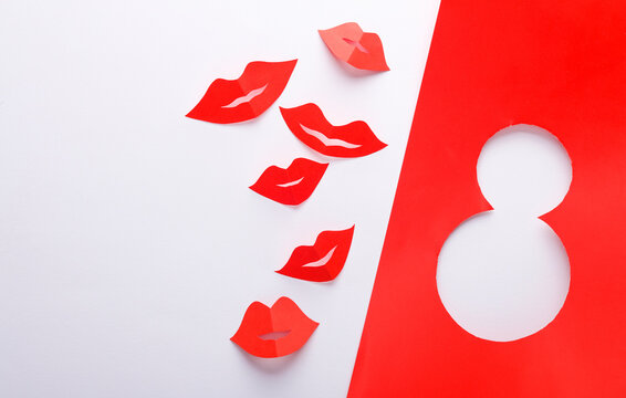 World Women's Day. March 8. Paper red lips with paper cut number 8 on white background