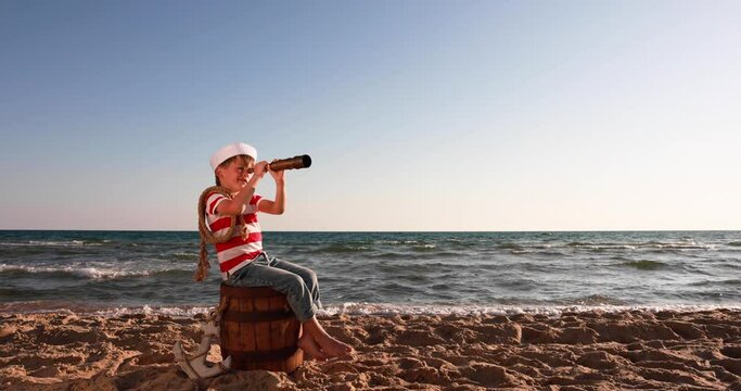 Boy looking through spyglass. Summer vacation and travel concept. Slow motion