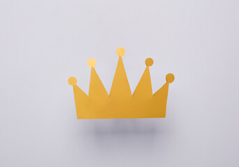 Paper golden crown on gray background