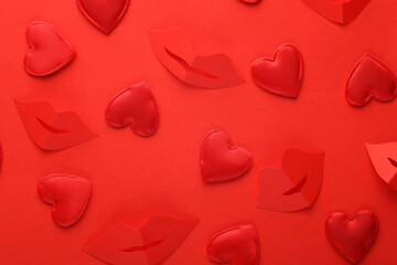 Cut out of paper a lot of red hearts with lips on red background. Valentine's day, love concept