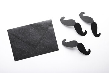 Envelope with paper mustache on a white background. Father's day