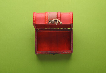 Red pirate chest on a green background. Top view