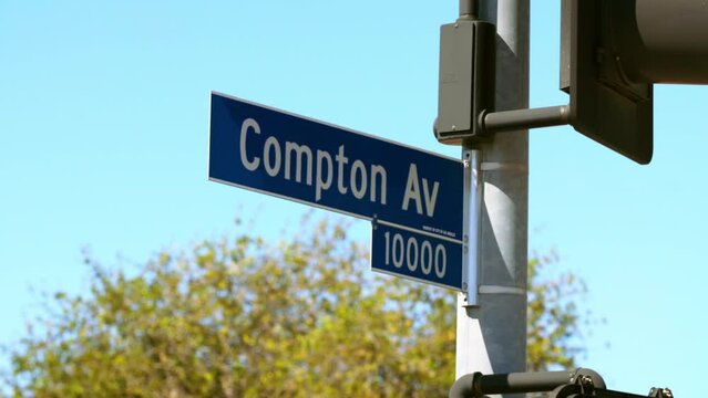 Lockdown Of A Blue Compton Street Sign Against A Bright Blue Sky  - Los Angeles, California