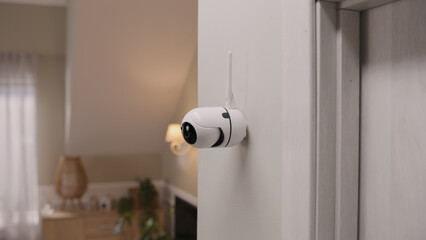 Close up shot of installed security camera on wall in modern apartment. CCTV camera with microphone...