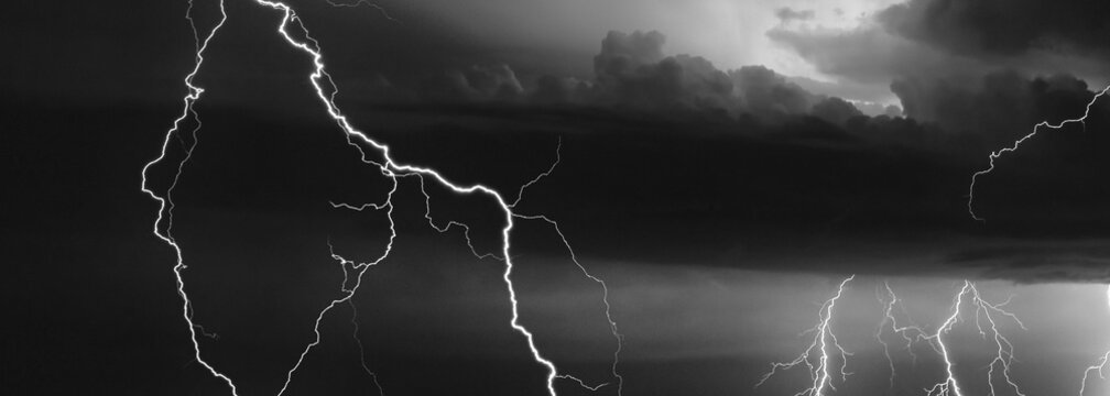 Thunder, lightnings, and rain on a stormy summer night in black and white