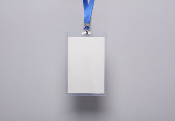 Empty white ID card badge mockup with blue belt on gray background. Staff identity name tag. Space...