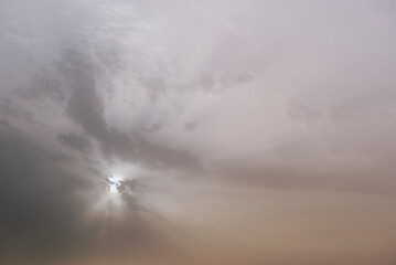 A sky, with diffused sun, clouds, colourful,