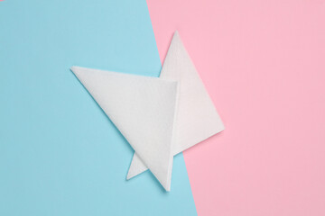 White paper napkins on pink blue background. Top view