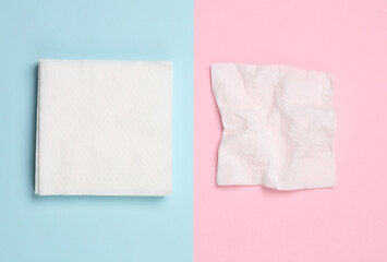 White paper napkins on pink blue background. Top view