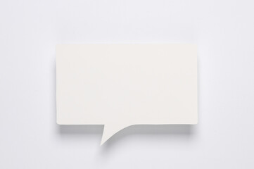 White blank paper-cut speech bubble on white background. Chat, social media, discussion. Mock up for template design
