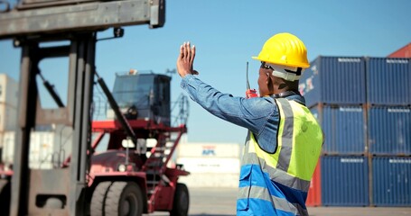 African professional engineer worker wearing safety vest and working in hard hat using with use a walkie-talkie on industry structure