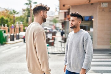 Young couple standing together with relaxed expression at street