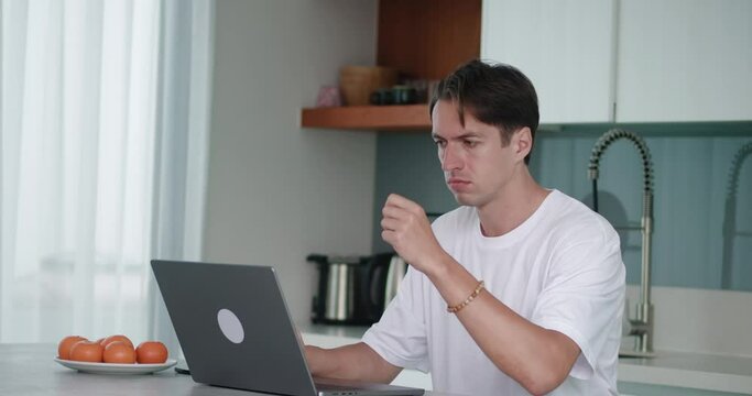 Angry man throws a credit card on table rage, at home kitchen, dissatisfied with lack of money for online purchase or blocking bank account. Financial difficulties. Insufficient funds in bank account.