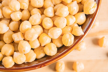 Boiled chickpeas in a brown bowl. Vegetarian cuisine concept.