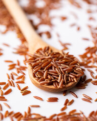 Wooden Spoon of Organic Raw Red Rice. Healthy Diet Concept