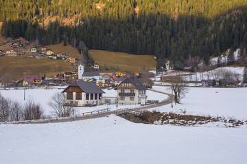 The snowy winter landscape near Sankt Margarethen in the Sankt Paul im Lavanttal municipality of the Wolfsberg District, Carinthia, Austria. The parish church of Sankt Margarethen is seen in the centr