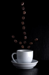 Floating Coffee Beans over White Cup on Dark Background