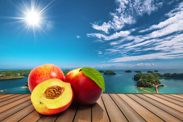 Peaches fruits on a table in front of a tropical sea