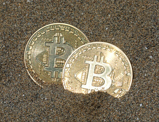 two Golden coins with B letter symbol of cryptocurrency called BitCoin