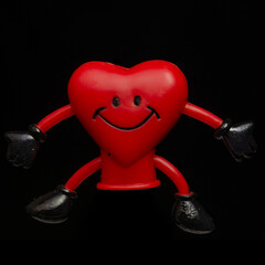 Heart shaped finger puppet on black background