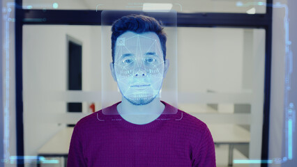 Fototapeta na wymiar Man scans face in office. He touches sensor and security system identifies person for access. 3D hologram of human innovative biometric facial recognition. Privacy, identification and AI technology.