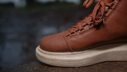 Close-Up of Brown Leather Shoes Treading on Wet Ground in the Rain