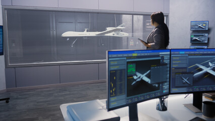 Engineers check aerodynamics of new development drone in laboratory for modern modifications using wind tunnel with steam. Computer system for changing parameters. Concept of manufacturing UCAVs. - obrazy, fototapety, plakaty