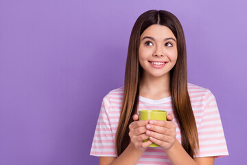 Photo of lovely adorable girl toothy smile hands hold hot chocolate cup look empty space isolated on violet color background