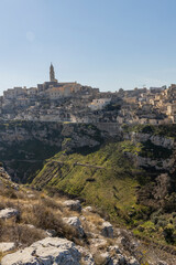 Fototapeta na wymiar Panorama of Matera, a UNESCO World Heritage Site. European Capital of Culture. View from the Murgia Park. Timeless walk inside Paleolithic caves. City similar to Jerusalem. Unforgettable journey