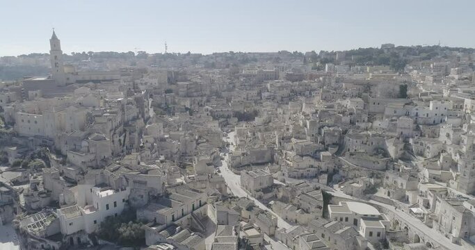Aerial view of Matera 4K. Flying around the ancient city in Italy. White and old buildings remember Jerusalem. View of Murzia Materana and the paleolithic caves. Panoramic flying. 