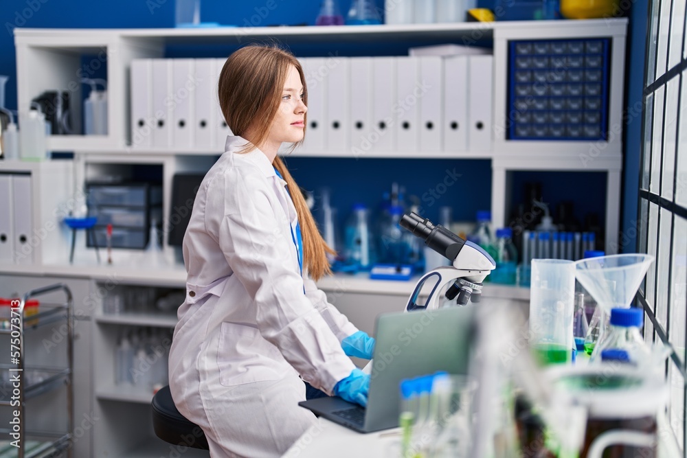 Sticker young caucasian woman scientist using laptop at laboratory