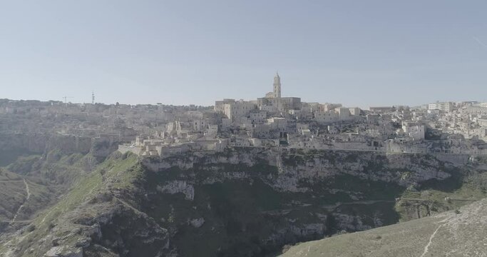 Aerial view of Matera 4K. Flying around the ancient city in Italy. White and old buildings remember Jerusalem. View of Murzia Materana and the paleolithic caves. Panoramic flying. 