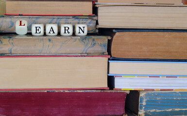 business concept, education and learning brings financial success, books and dices with wordplay