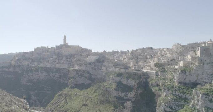 Aerial view of Matera 4K. Flying around the ancient city in Italy. White and old buildings remember Jerusalem. View of Murzia Materana and the paleolithic caves. Panoramic flying. 