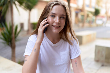 Young caucasian woman smiling confident talking on the smartphone at street