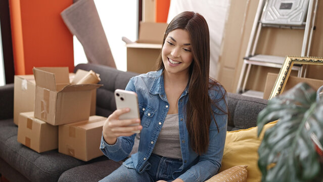 Young beautiful hispanic woman smiling confident make selfie by smartphone at new home