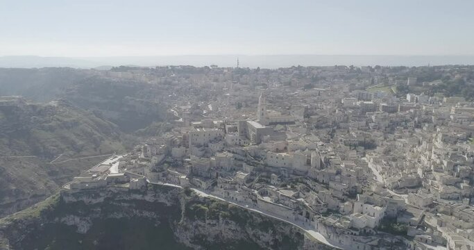 Aerial view of Matera 4K. Flying around the ancient city in Italy. White and old buildings remember Jerusalem. View of Murzia Materana and the paleolithic caves. Panoramic flying. 