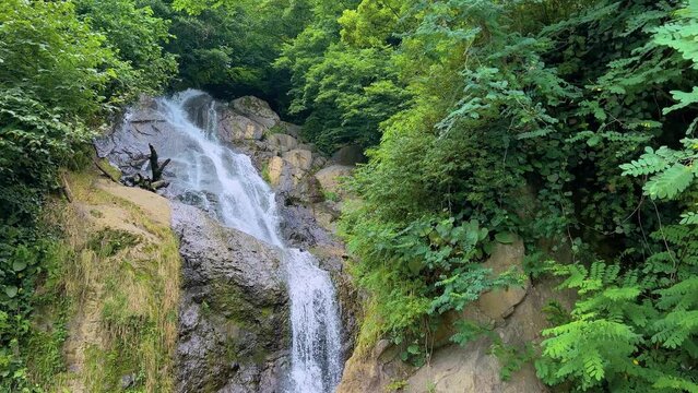 River or water stream flowing and falling down - Andrew the Apostle waterfall in the mountain in Batumi, Georgia. Nature, landscape and environment concept