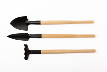 Garden shovel and fork, garden rake isolated on white background. Gardening Tools.