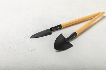 Garden tools on a light concrete background. Space for text. Space for copy. Top view. Gardening concept.Working in the garden.Hobby. Garden shovels on a textured background.