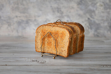 Toast bread in vintage holder on wood rustic table. Delicious toast ready for eat. 