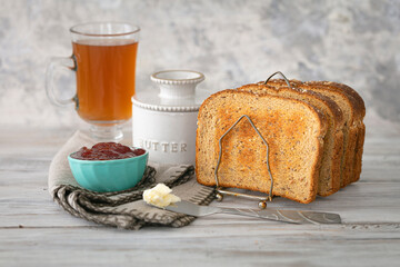 Traditional classic light breakfast or dinner toast, butter, jam, tea and egg. Rustic white...