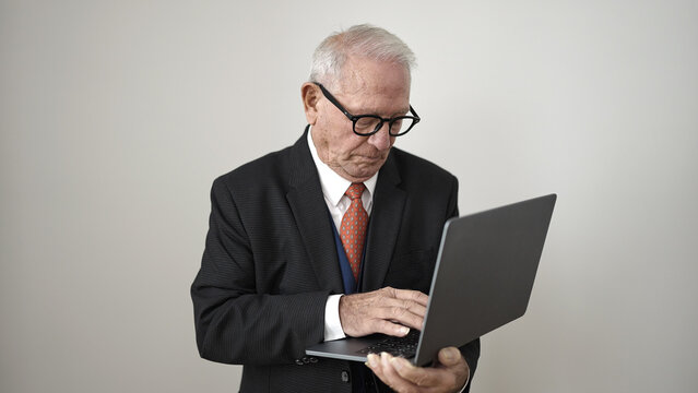 senior standing using laptop over isolated white background