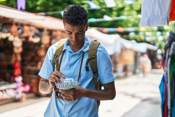 African american man tourist counting dollars at street market