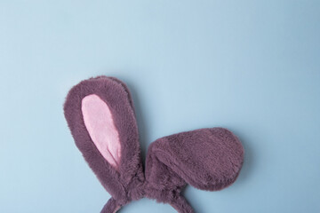 Top view of fluffy bunny rabbit ears on blue background. Easter minimal concept.