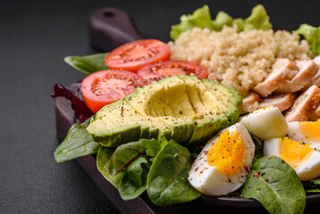 Delicious healthy lunch consisting of chicken, avocado, quinoa, eggs and tomatoes
