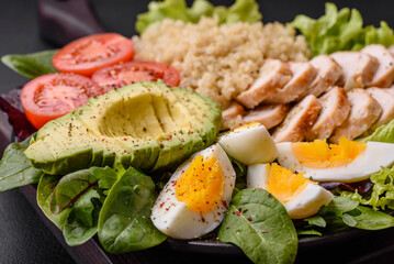 Delicious healthy lunch consisting of chicken, avocado, quinoa, eggs and tomatoes
