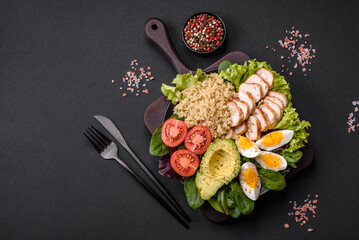 Delicious healthy lunch consisting of chicken, avocado, quinoa, eggs and tomatoes