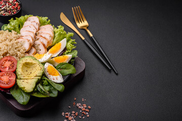 Delicious healthy lunch consisting of chicken, avocado, quinoa, eggs and tomatoes