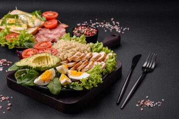 Delicious healthy lunch consisting of chicken, avocado, quinoa, eggs and tomatoes